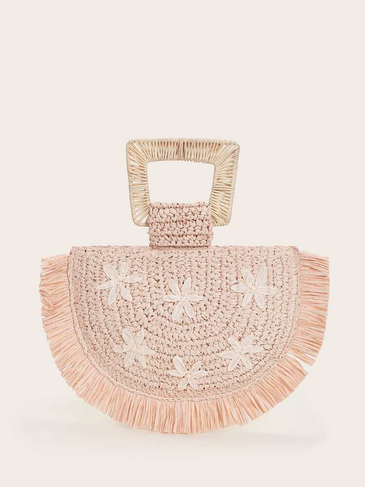 light pink straw bag with woven top handle with floral detail in front