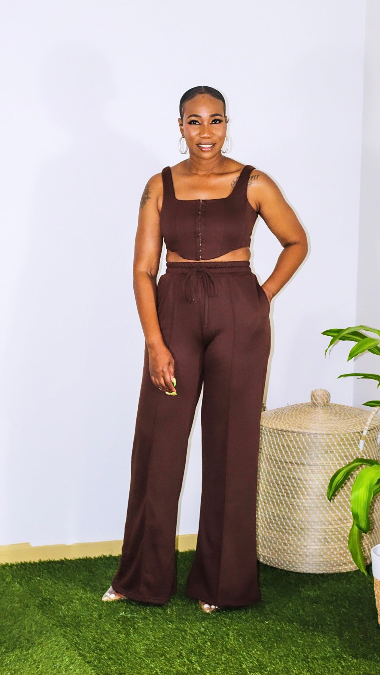 Coco Bean Set is available in two pieces, crop top has a hook closure with boning detailing in front with square neckline. Pants are high waisted with elastic waistband, drawstring and pockets. 